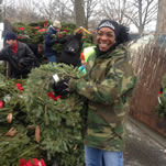 Female volunteer holds wreaths at Arlington cemetery.